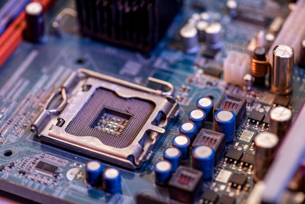 Close-up image of a computer motherboard, highlighting the CPU socket and various capacitors and components surrounding it, crucial for supporting Xeon Processors in high-performance computing (HPC) technology.