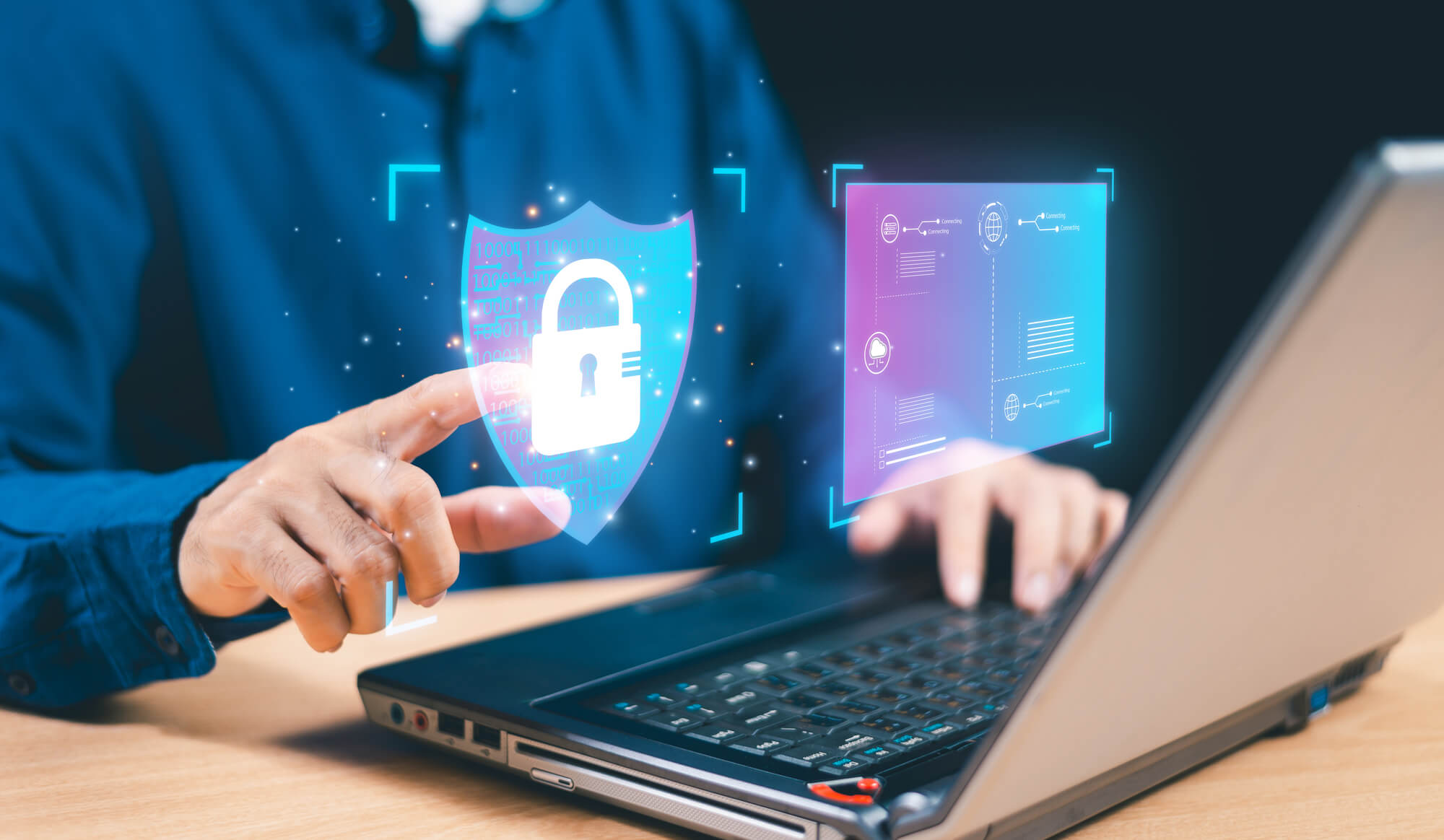 A person using a laptop, interacting with a digital padlock icon, represents cybersecurity and data protection, showcasing advanced technology at an AFITC event.