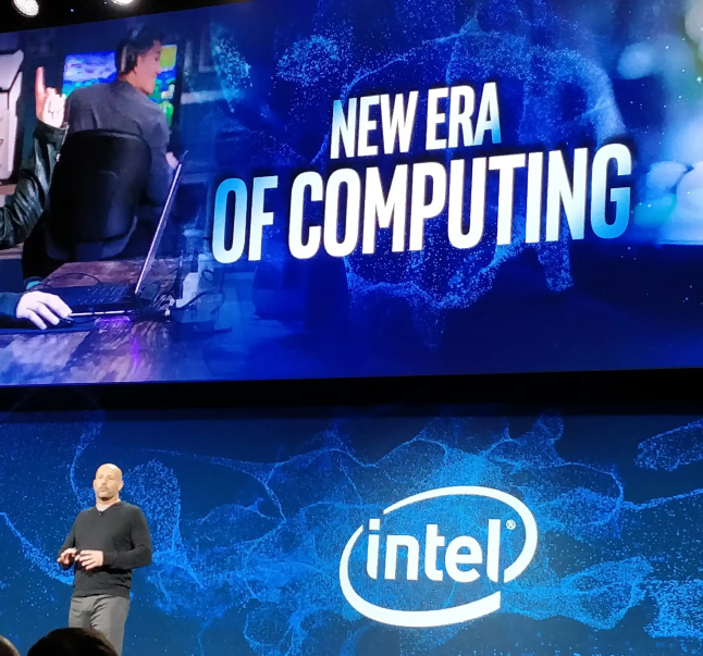 A man presents on stage at an Intel event, proudly holding the "2019 Intel Partner of the Year Award," with a backdrop reading "NEW ERA OF COMPUTING.