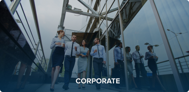 Group of business professionals walking and talking in a modern glass building corridor of their new home.