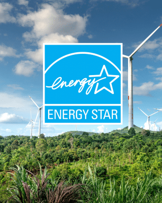 ENERGY STAR logo overlaid on a landscape with wind turbines and green vegetation under a partly cloudy sky, highlighting the benefits of ENERGY STAR Certified renewable energy solutions.