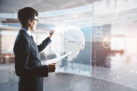 A man in a suit interacts with a large transparent screen displaying a digital globe, charts, and data in a modern office, highlighting secure on premise AI solutions for advanced business intelligence.