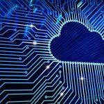 Blue digital illustration of a cloud icon surrounded by circuit board patterns, symbolizing cloud computing and data technology.
